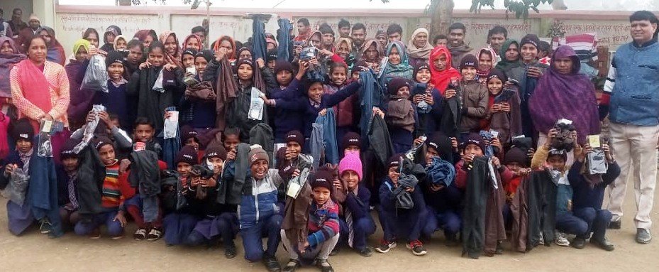 Children with donated winter clothing and blankets, Sponsorship Program